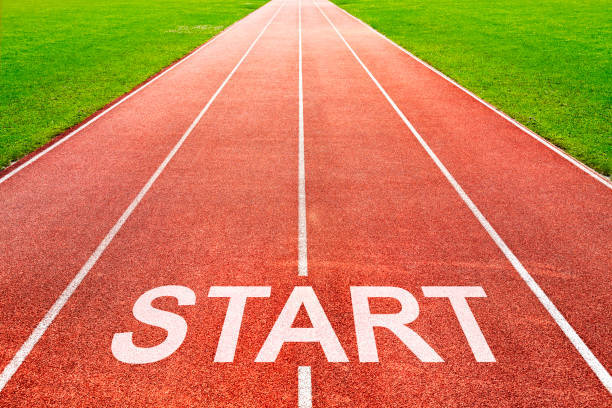 Start written on race starting line on of running track of stadium sports field